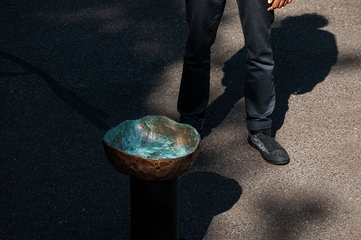 Bronze urinal bowl with blue oxidising colouring the surface