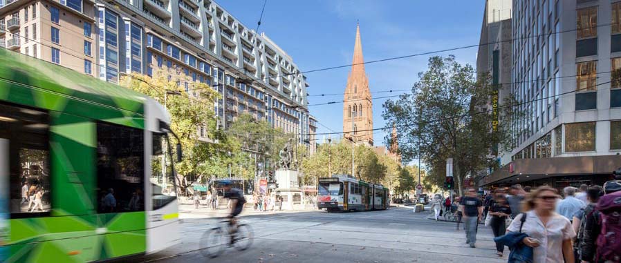 Pedestrians, cyclists and trams on Swanston Street near City Square