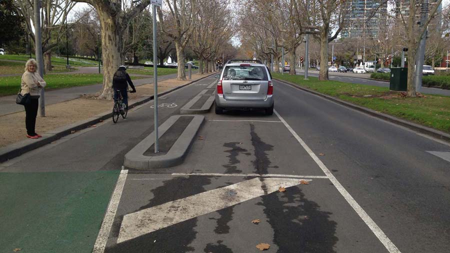 Section of the bike lane on St Kilda Road, alongside the kerb and physically separated from parked cars on the right