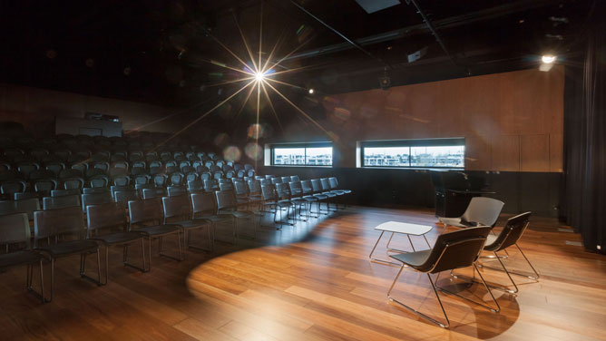 Performance space with wooden floors and full seating