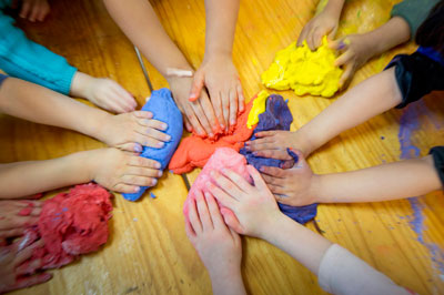 Children's hands moulding colourful playdough