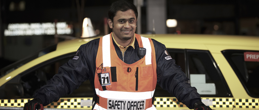 Safety officer standing next to taxi